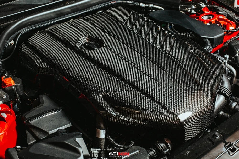 Toyota GR Supra B58 engine components laid out: stroker kit rods, BC camshafts, forged pistons and bearings showcasing high-performance B58 build parts